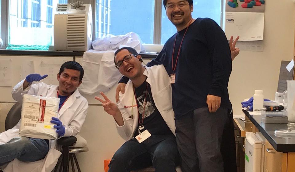 three lab team members in a lab room